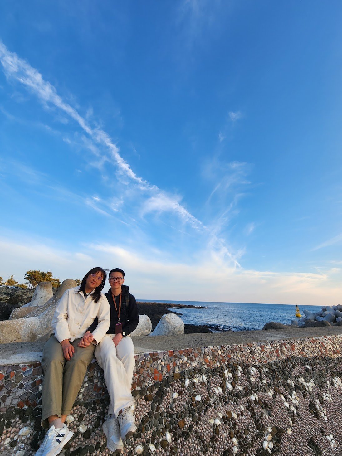 Ben and his mother sitting together by the sea