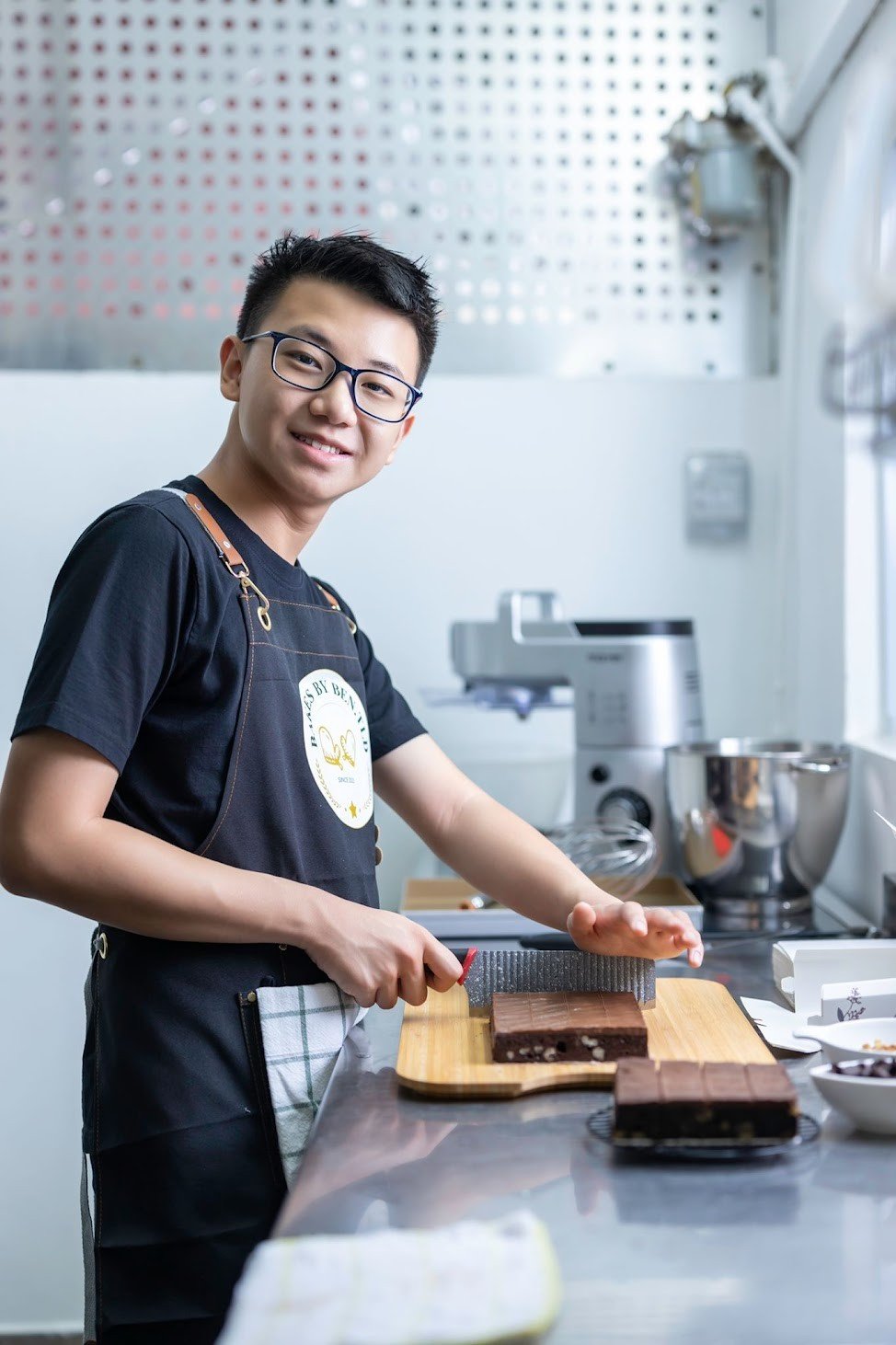 Ben cutting fresh brownies in the kitchen